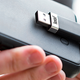 Illustration for article titled This Curvy Flash Drive Hides Behind Your iPhone So It's Less Intrusive